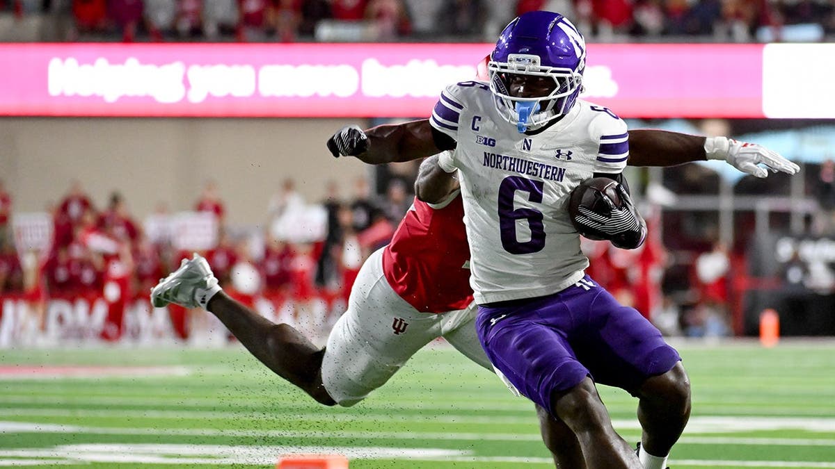 Joseph Himon II runs the ball against Indiana Hoosiers during a football game.