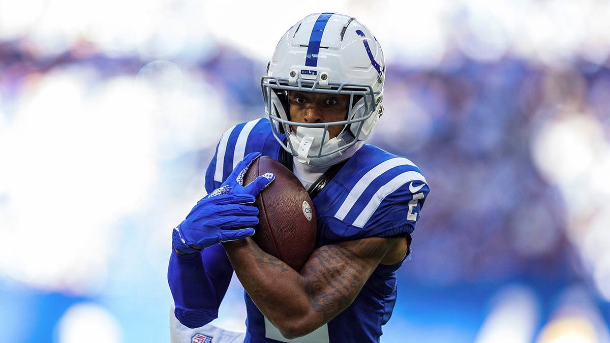 Josh Downs runs with the ball during NFL game action against the Tennessee Titans.