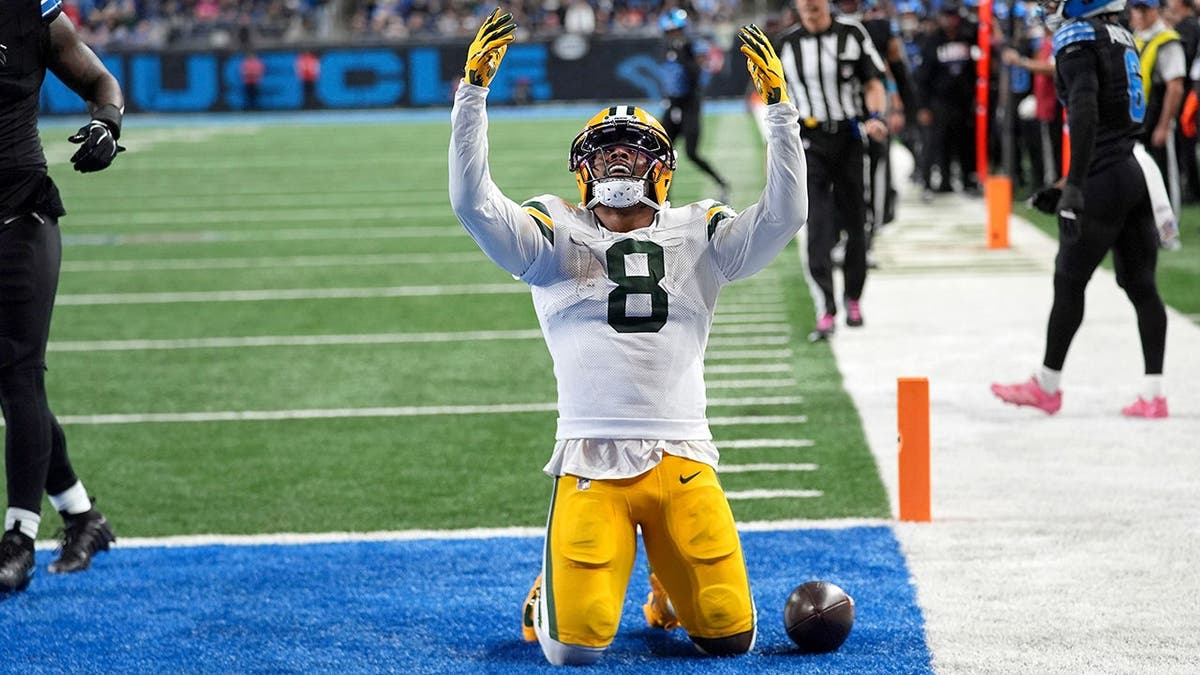 Josh Jacobs celebrates after scoring a touchdown reception during an NFL game against Detroit.
