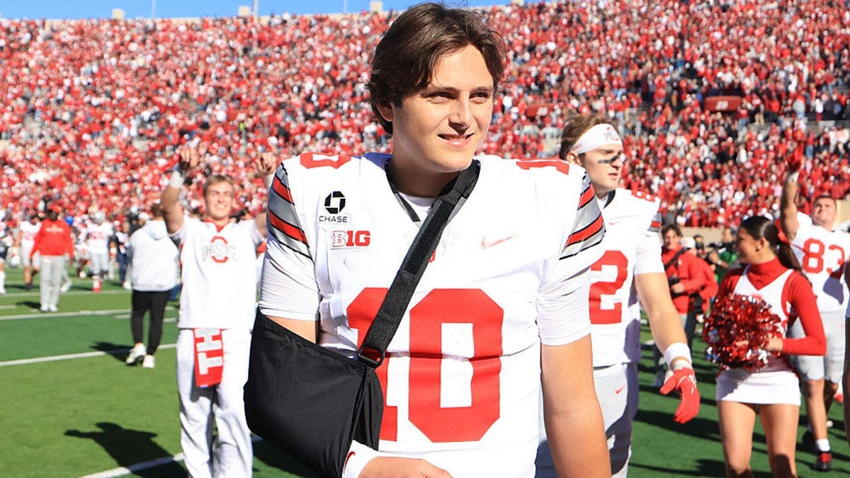 Julian Sayin walks off the field with his arm in a sling.