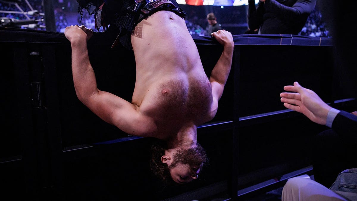 Jungle Jack Perry lies on the barrier during an AEW Grand Slam event in Paris.