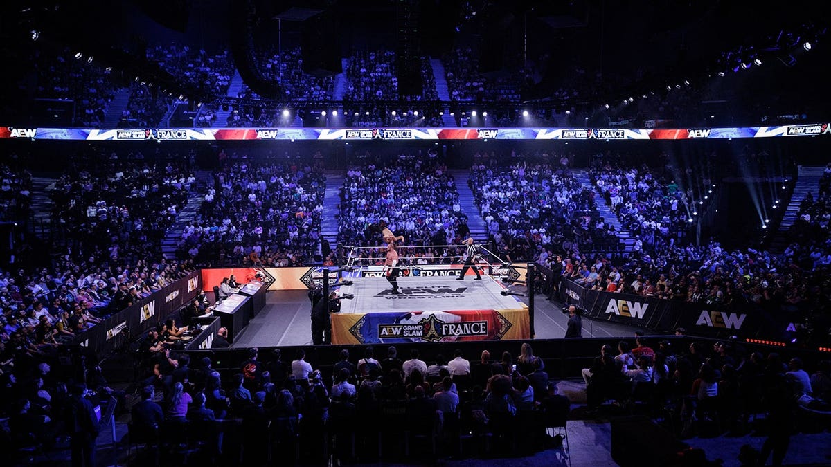 Jungle Jack Perry and Samoa Joe perform in a wrestling ring at the Adidas Arena in Paris.
