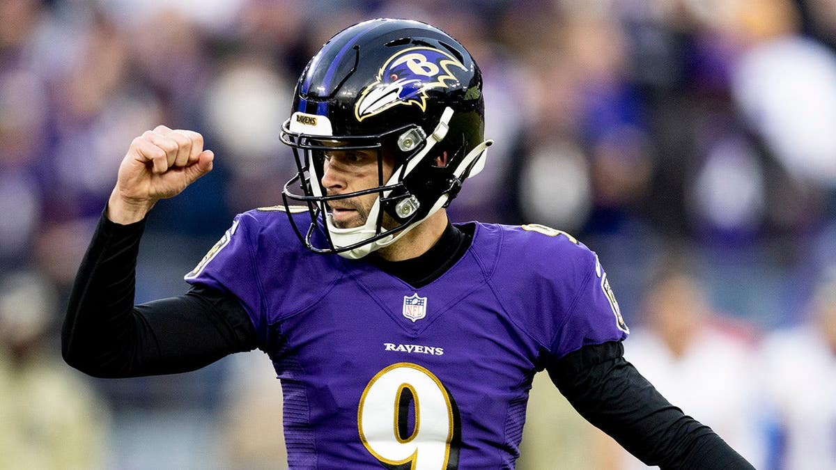 Justin Tucker celebrates after kicking a 36-yard field goal during an NFL game.