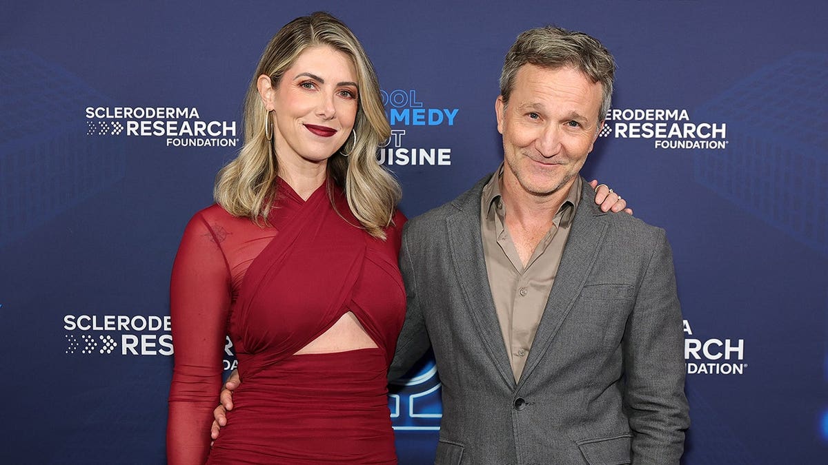 Kelly Rizzo and Breckin Meyer stand together at the Cool Comedy Hot Cuisine benefit.