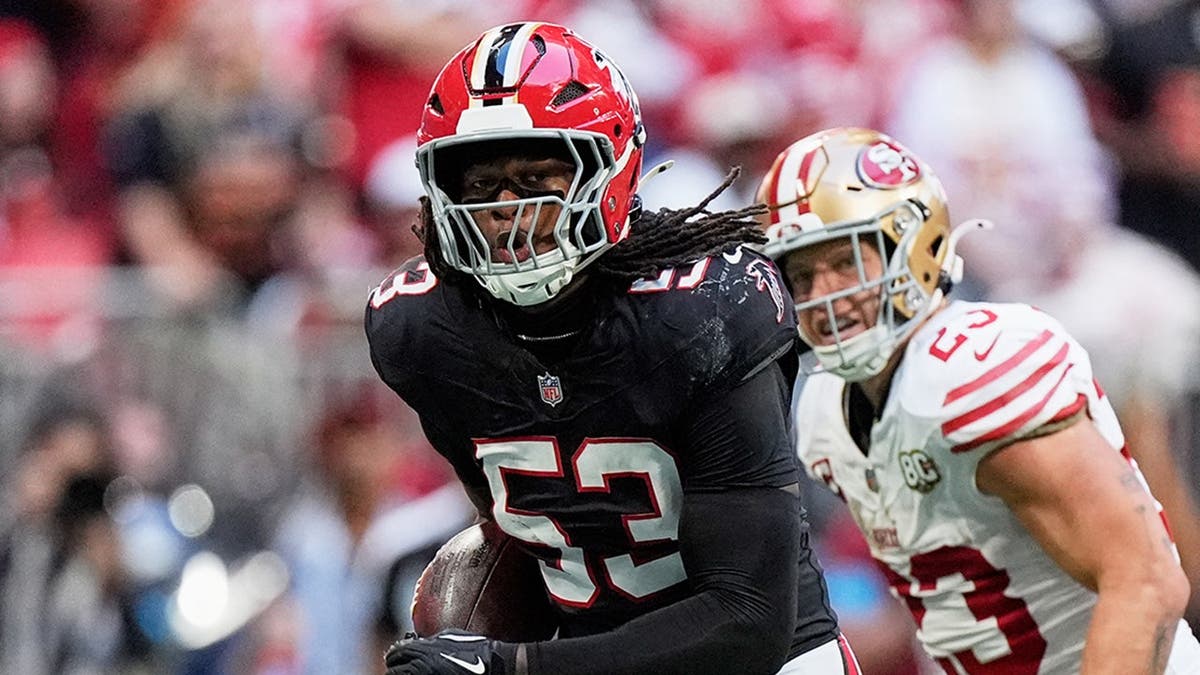 Kendal Daniels returns an interception as Christian McCaffrey and Trent Williams chase him.