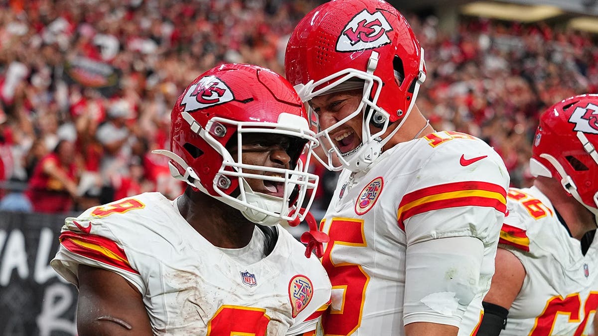 Kenneth Walker III and Patrick Mahomes celebrate after a touchdown at Allegiant Stadium.
