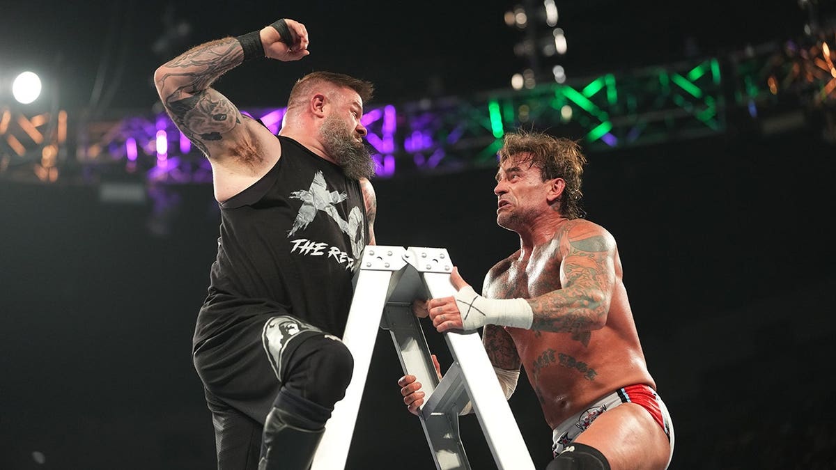 Kevin Owens grapples with CM Punk in the ring during Money in the Bank.