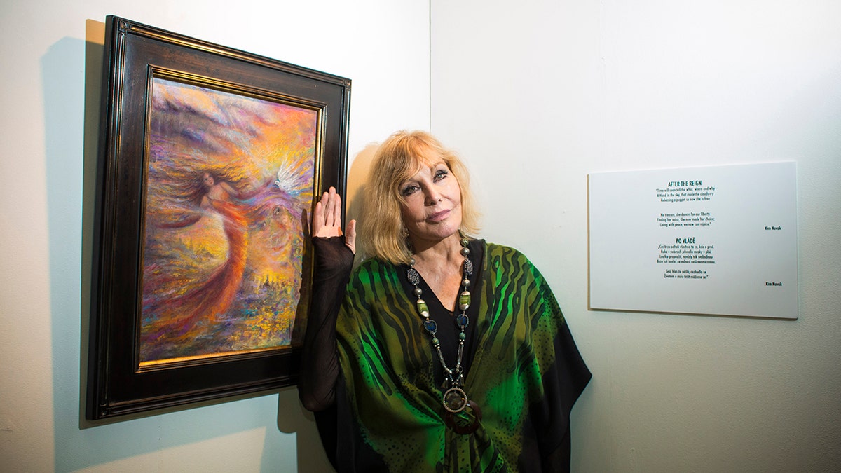 Kim Novak poses with her painting at a photocall during the Febiofest Prague International Film Festival.