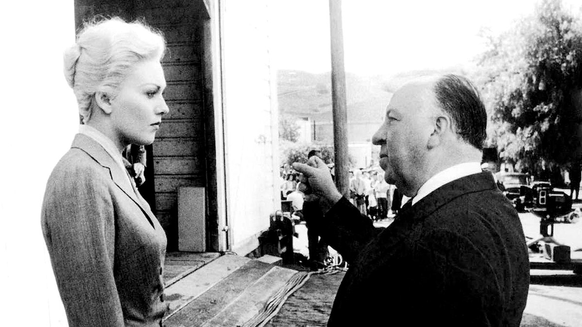 Kim Novak listening to Alfred Hitchcock.