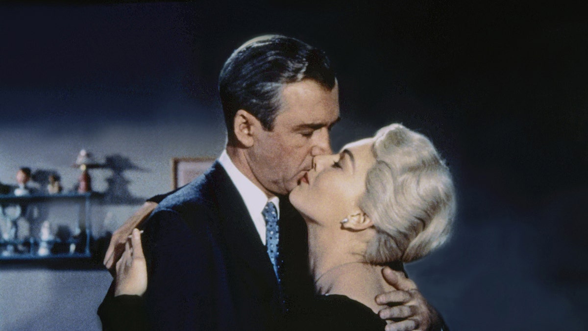 James Stewart and Kim Novak stand together on the Vertigo film set.