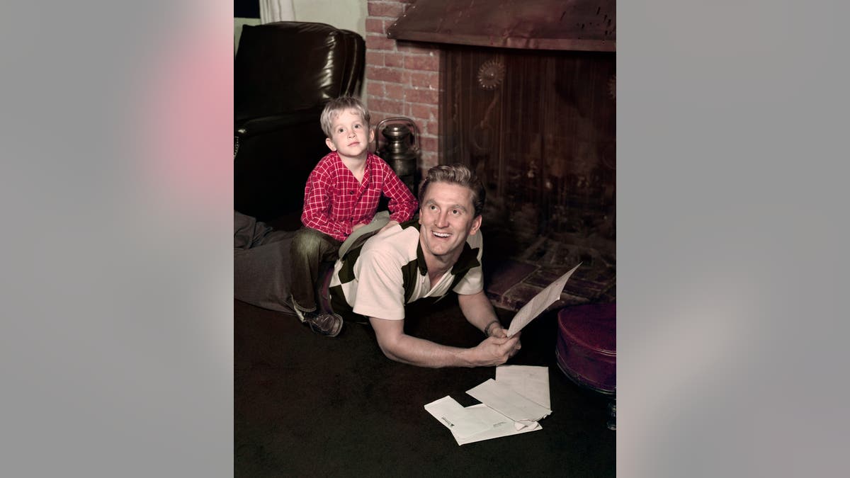 Kirk Douglas stands with his son Michael Douglas.