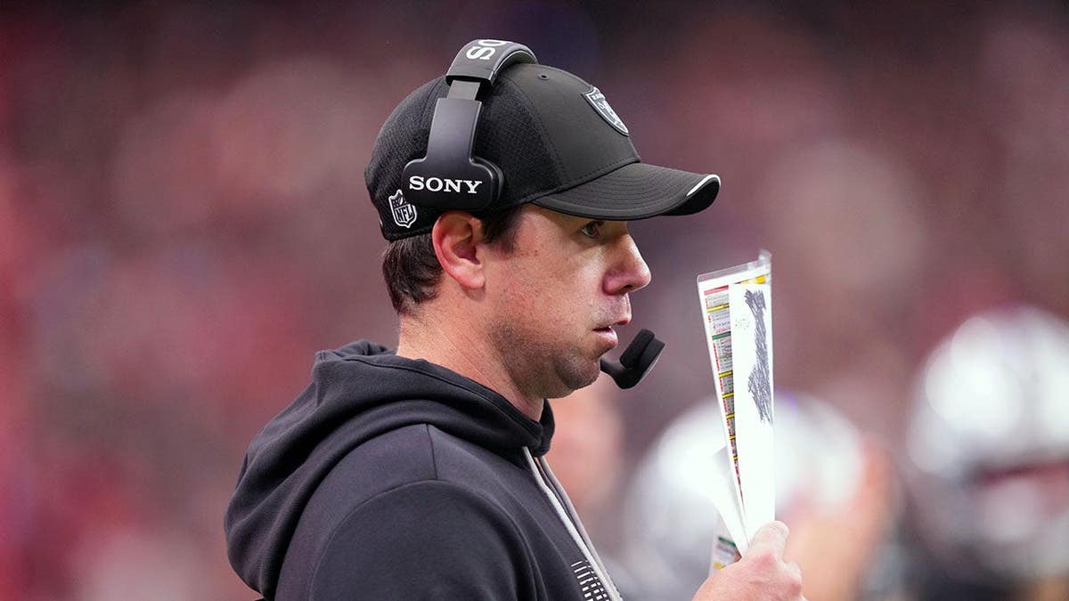 Klint Kubiak, Las Vegas Raiders head coach, watches game play during the third quarter.