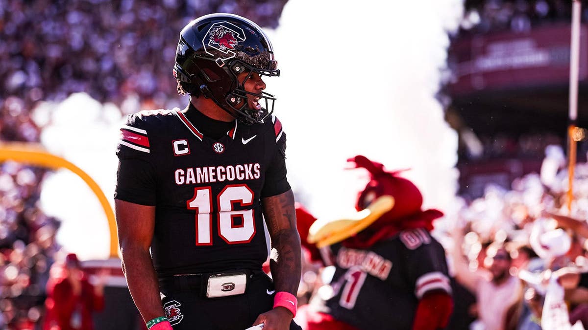 LaNorris Sellers #16 celebrates after a touchdown during a football game.