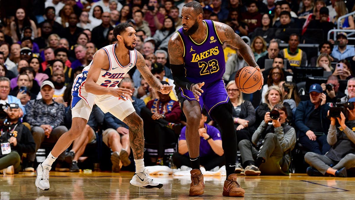 LeBron James handles the ball during a Lakers game against the 76ers.