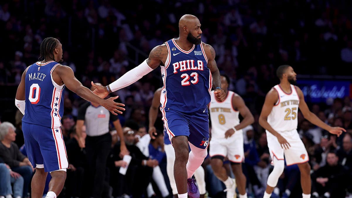 LeBron James and Tyrese Maxey shake hands during an NBA game at Madison Square Garden.