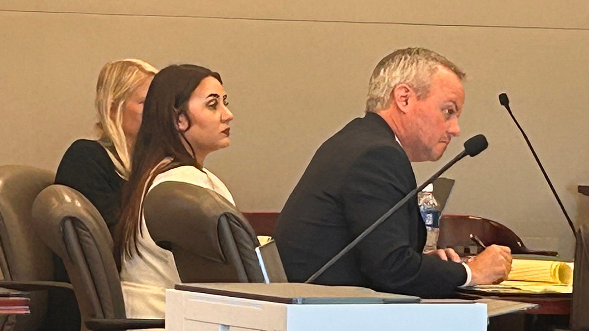 Leigha Mumby sits between attorney Reid Hart and a legal assistant during jury selection in Bunnell, Florida