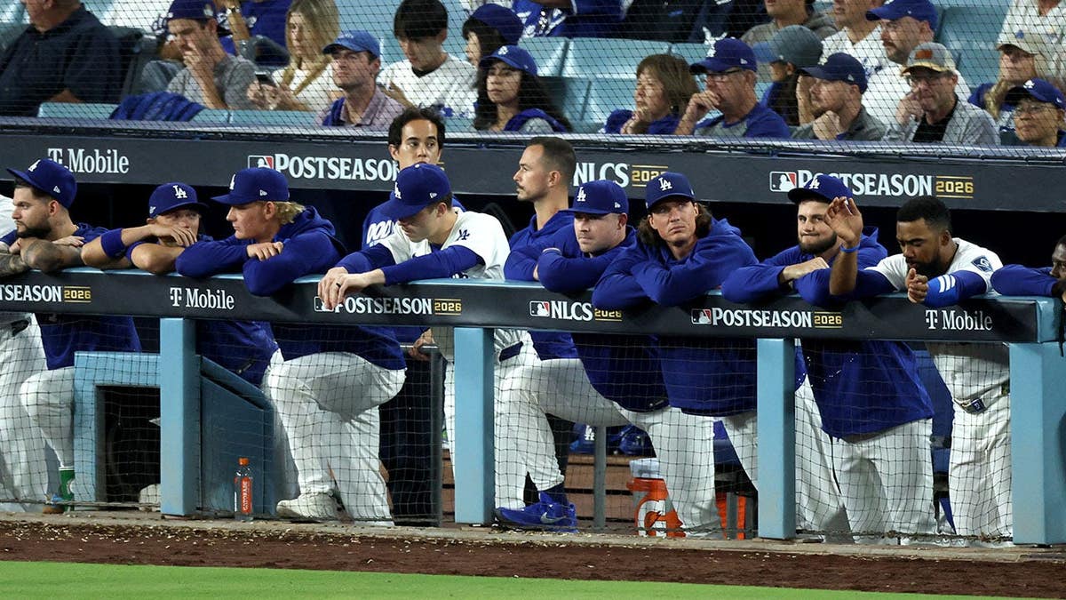 Los Angeles Dodgers players look on from the dugout during the eighth inning.