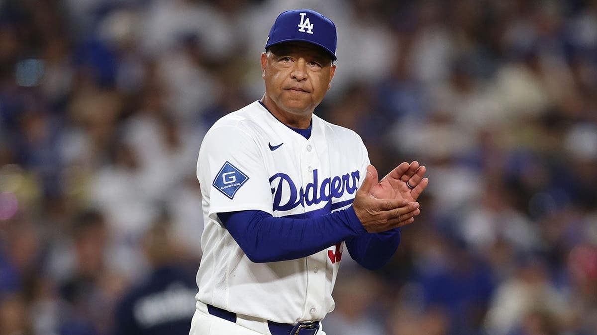 Dave Roberts walks to the mound during the eighth inning at Dodger Stadium.