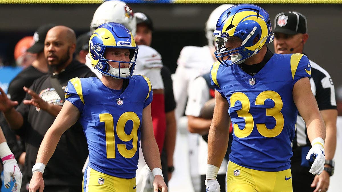 Blake Grupe and Dean Connors talk during an NFL game at SoFi Stadium.
