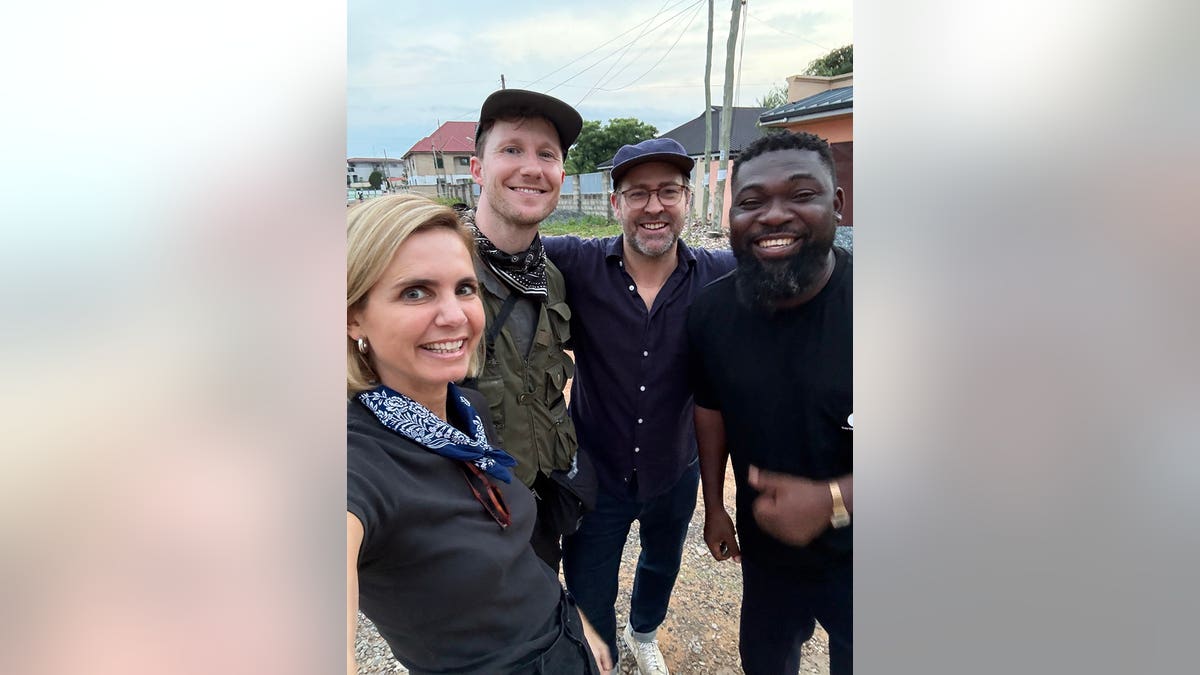 Mariana van Zeller poses with three men in Accra, Ghana.