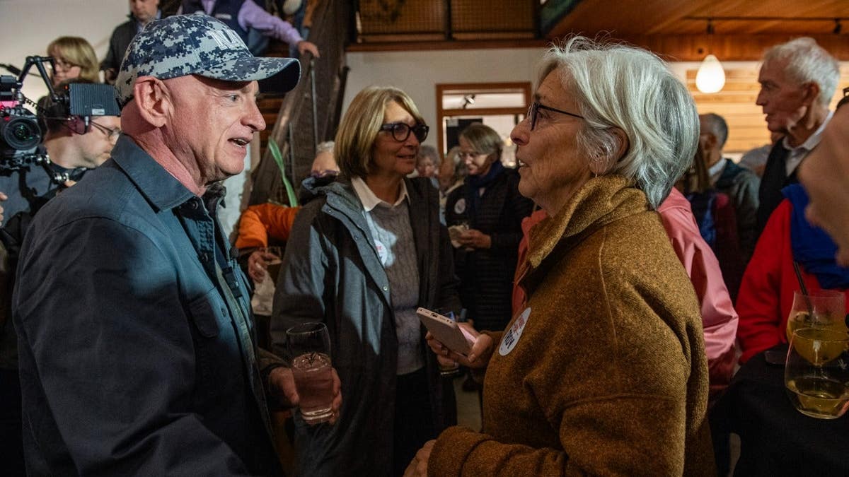 Sen. Mark Kelly, D-Ariz., greets a supporter at a campaign event for Senate candidate Troy Jackson.