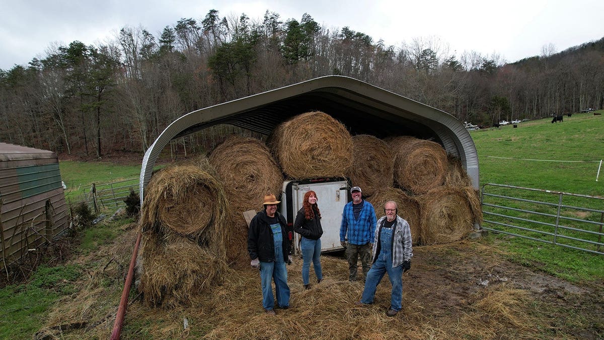 Mark Ramsey, Amanda Bryant, Kelly Williamson and Eric Digger Manes stand in front of a hay barn still site.