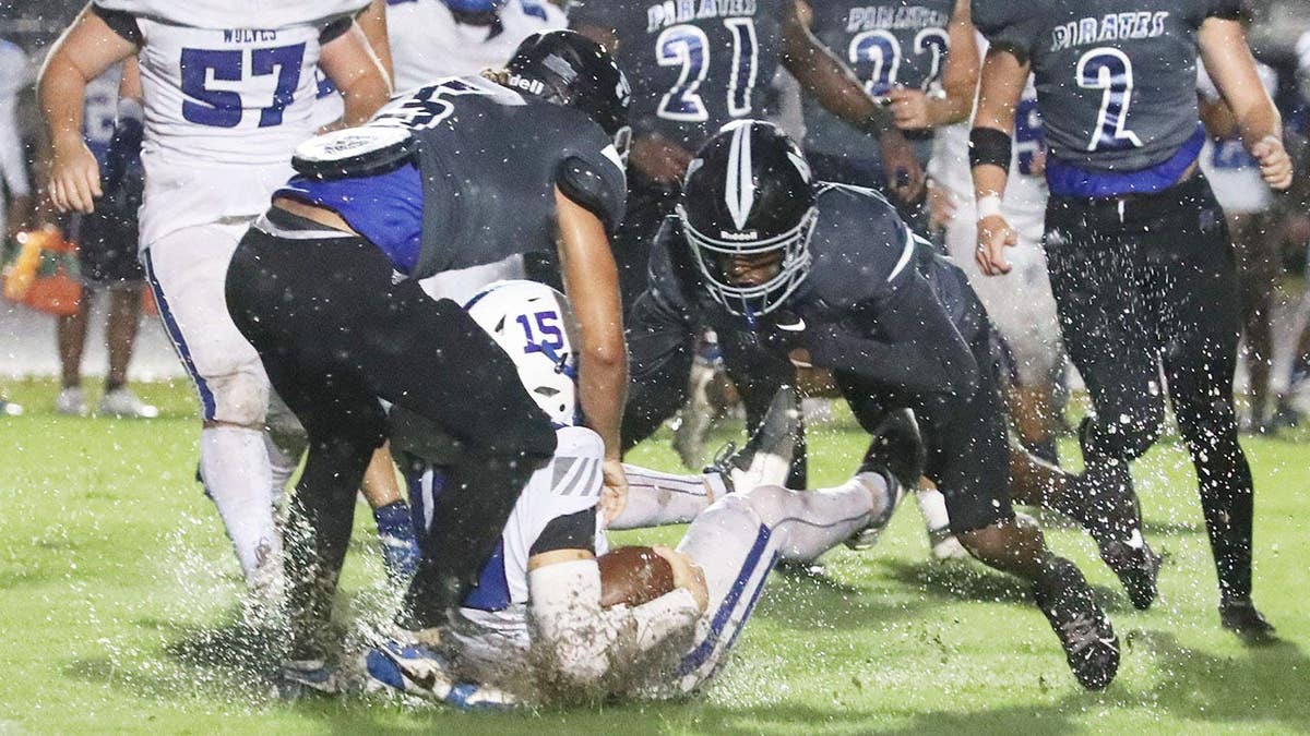 Matanzas defenders tackle Deltona quarterback Jeremiah Hancock during a football game in Palm Coast.