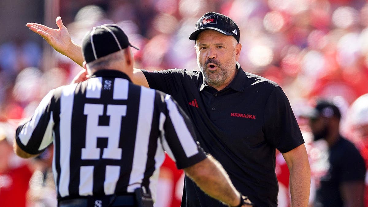 Matt Rhule argues with a game official during a football game.