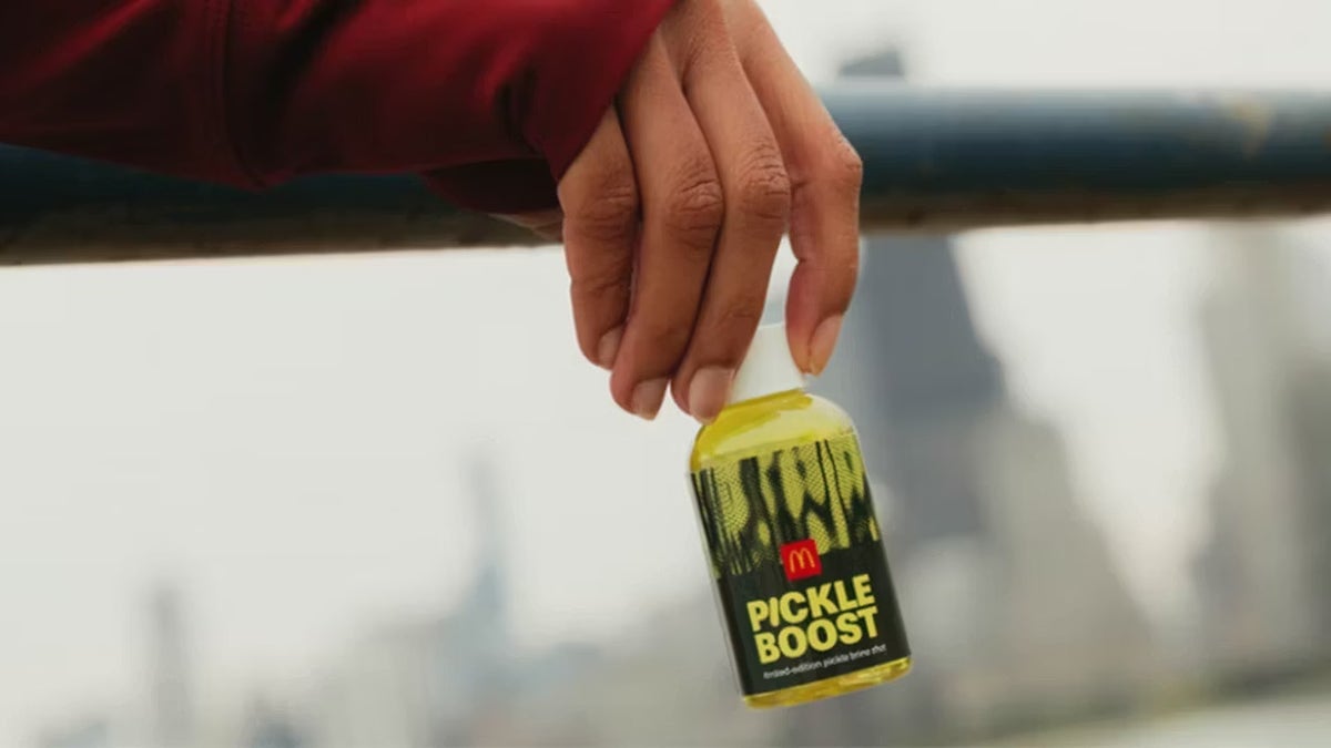 Hand holding McDonald's pickle boost drink
