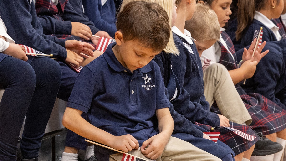 Student holding American flag