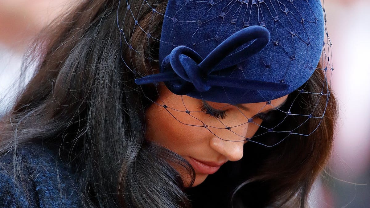 Meghan, Duchess of Sussex bows her head at Westminster Abbey.