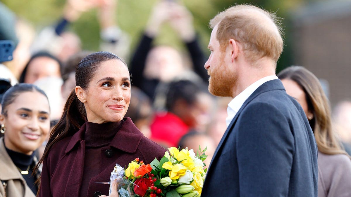 Meghan, Duchess of Sussex and Prince Harry, Duke of Sussex arrive at a building in Nottingham, England.