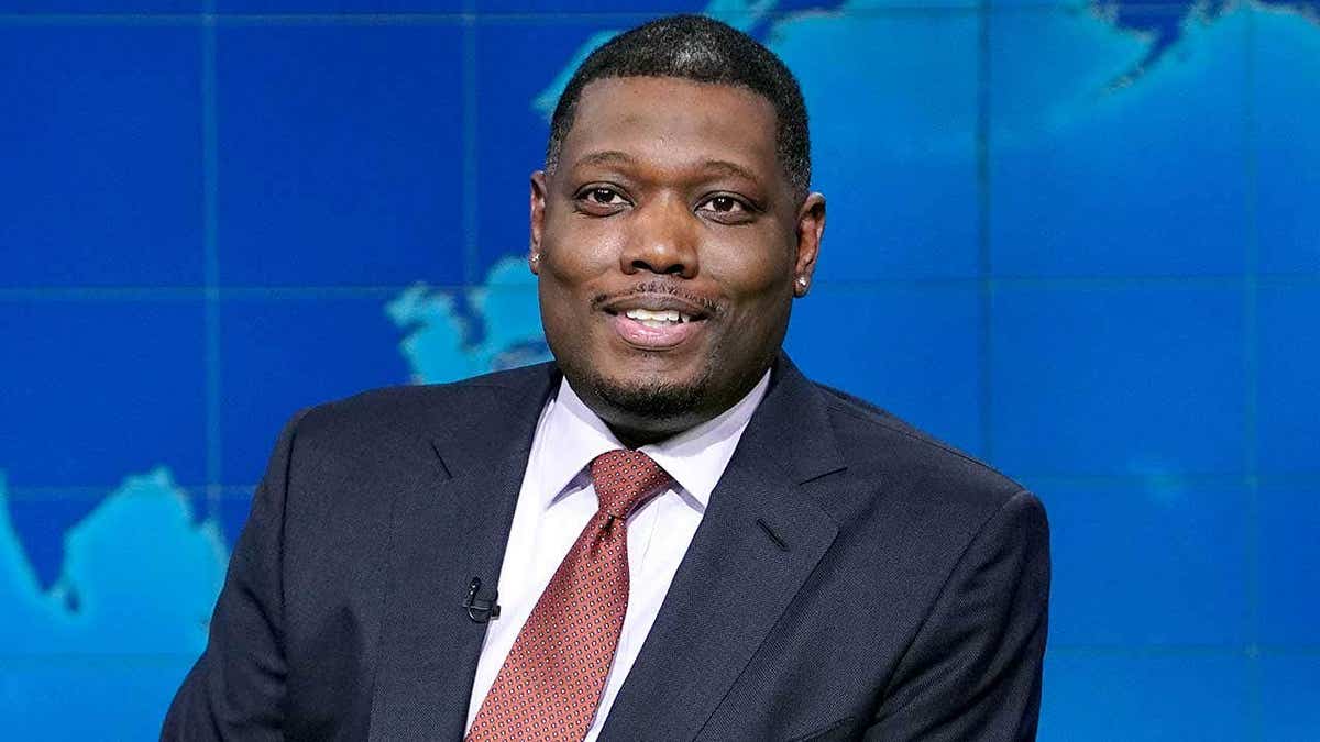 Michael Che sits at the Weekend Update desk on Saturday Night Live.
