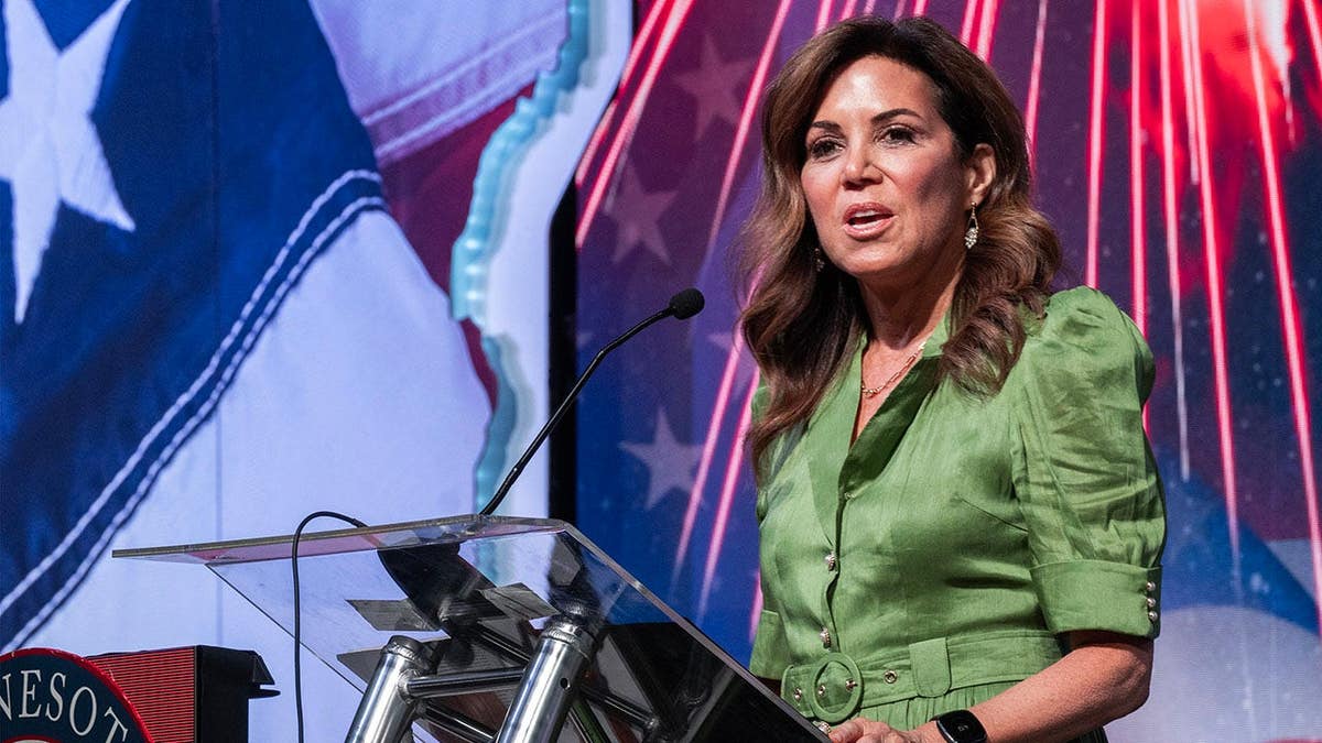 Michele Tafoya speaks at a podium at the Minnesota Republican state convention in Duluth, Minn.