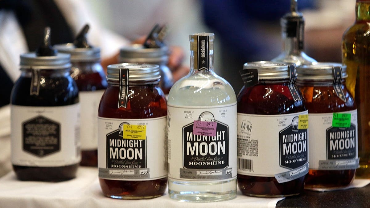 Midnight Moon bottles displayed at a bar during NASCAR Fan Appreciation Day at the NASCAR Hall of Fame in Charlotte, N.C.