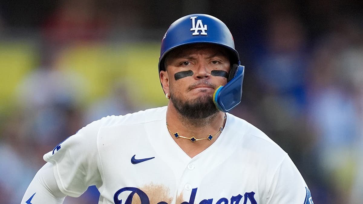 Miguel Rojas runs out a base hit during Game 3 of the National League Championship Series.