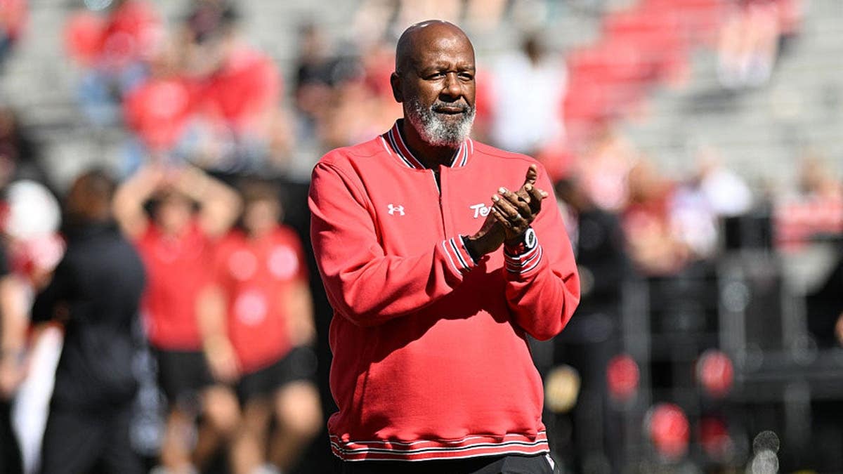 Mike Locksley watches Maryland warm up before the game.