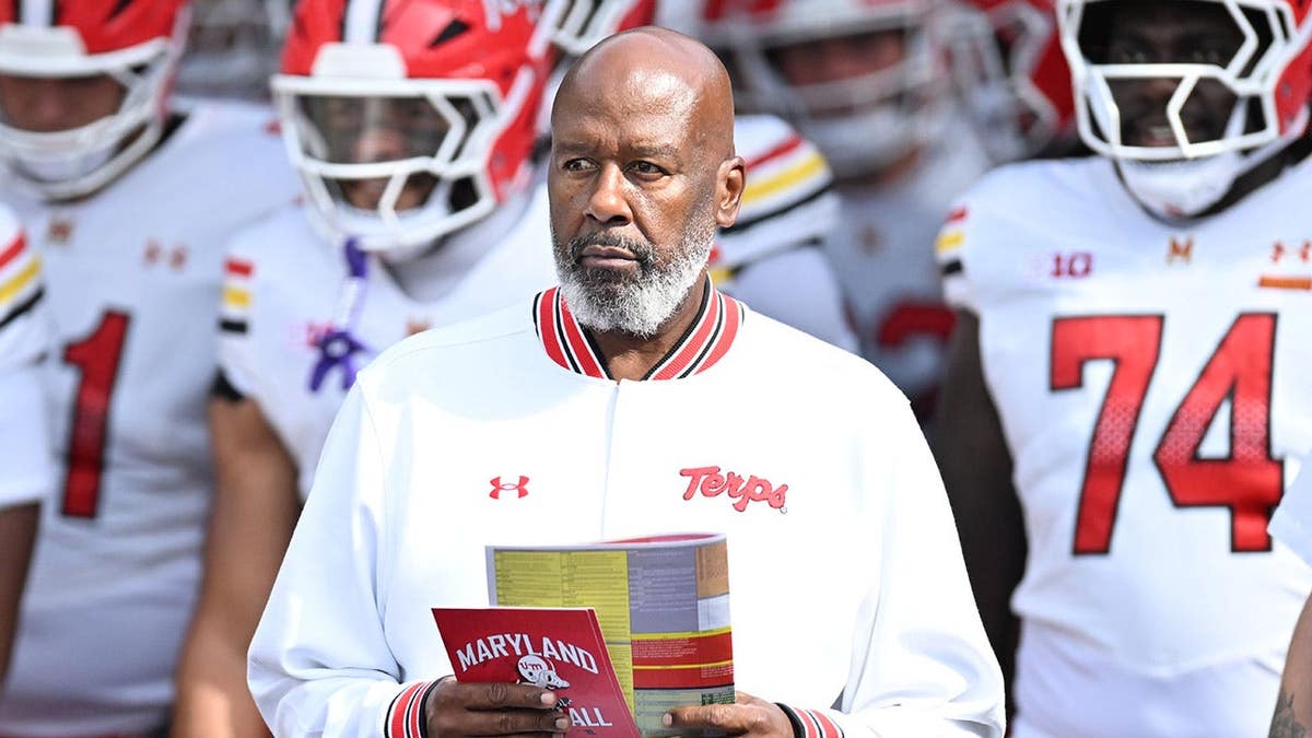 Mike Locksley leads Maryland Terrapins onto the field at Pratt & Whitney Stadium.