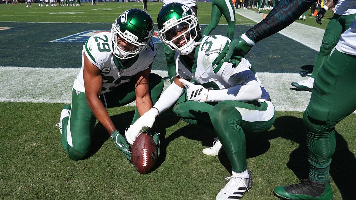 Minkah Fitzpatrick celebrates with Qwan'tez Stiggers after an interception during an NFL game.
