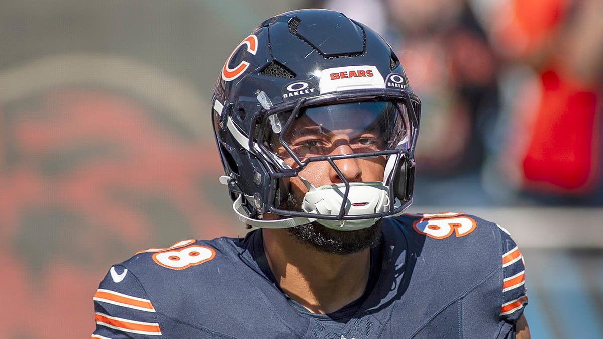 Montez Sweat takes to the field before an NFL game in Chicago.