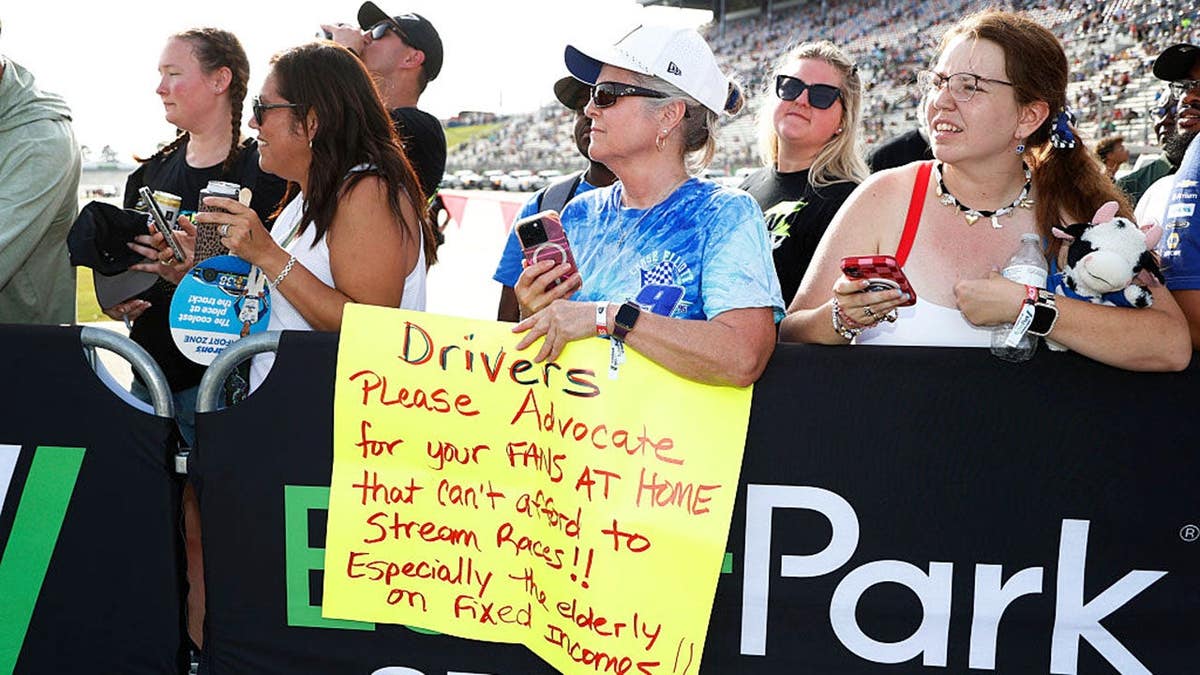 A fan holds up a sign during driver introductions at EchoPark Speedway.