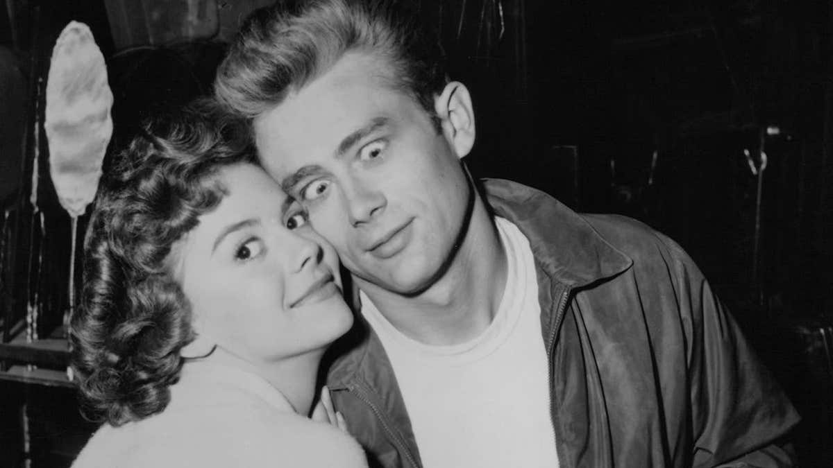 Natalie Wood and James Dean stand together on a film set.
