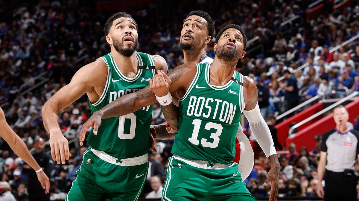 Jayson Tatum and Paul George box out during a Boston Celtics game against the Detroit Pistons.