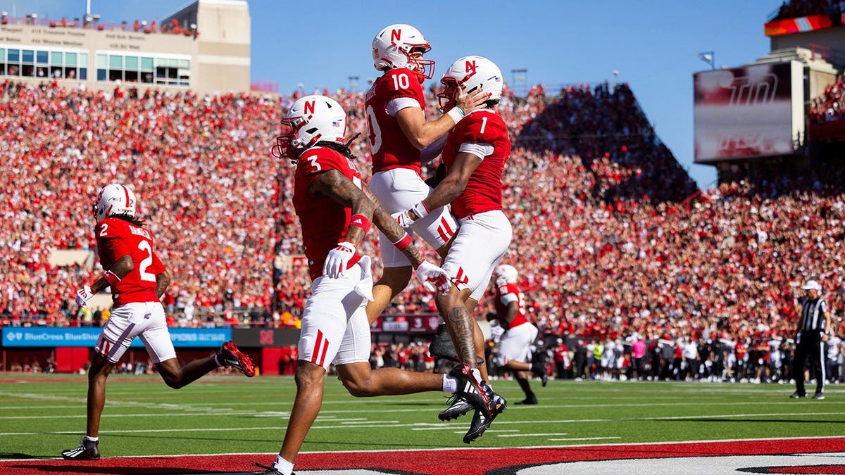 Nebraska quarterback Anthony Colandrea and receiver Nyziah Hunter celebrate a touchdown.