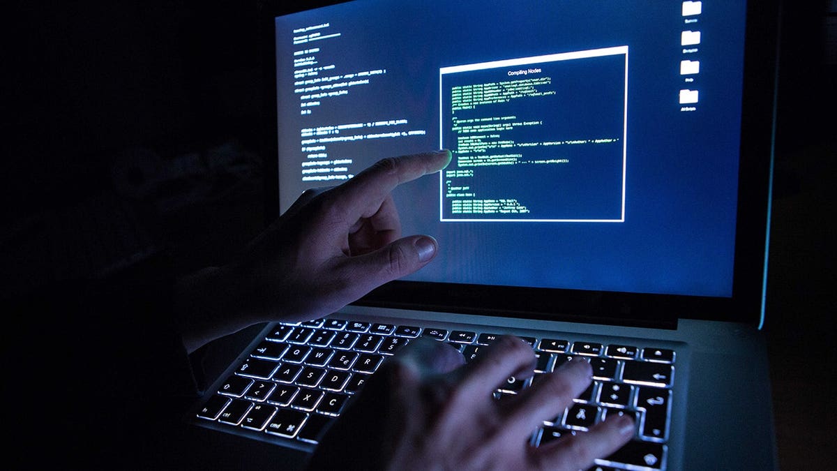 Hacker typing out code.
