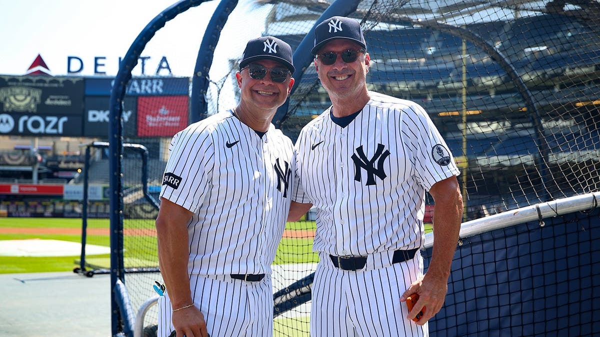 Nick Swisher and Tino Martinez pose for a photo at Yankee Stadium.