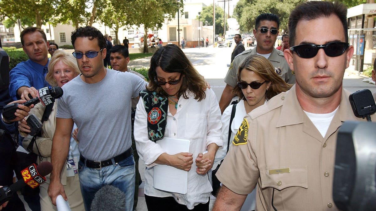 Noah Blake, Noreen Austin and Delinah Blake walk outside a courthouse.