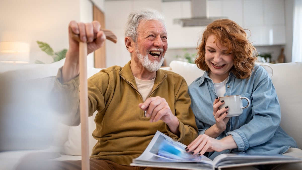 Older man laughing with young woman