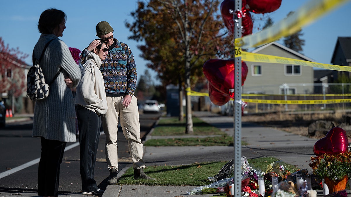 From right, Kyle Ketchum embraces Christina Edwards at a makeshift memorial outside Silver Rail Elementary in Bend, Ore., Friday, Oct. 16, 2026, a day after a deadly shooting.