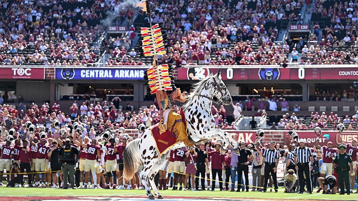 Osceola and Renegade plant the spear before a game at Doak S. Campbell Stadium.